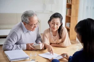 Older couple reviewing legal documents with attorney